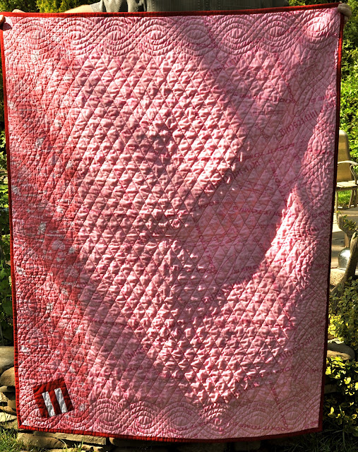 Barb has pieced two different pieces of pink fabric for the back of this quilt. Most of the backing is one piece, but there is a small strip on the left that is another, but similar, fabric.