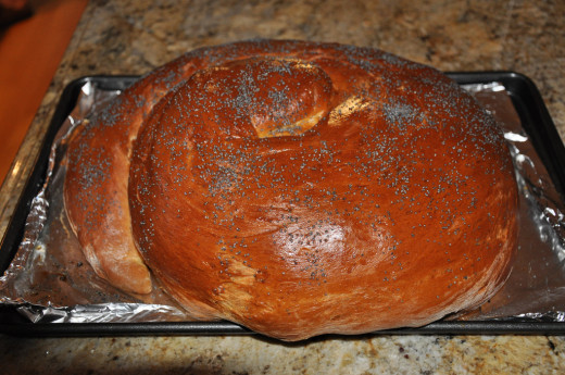 This is a traditional round challah for Rosh Hashanah, dusted with poppy seeds. Common variations include using raisins inside for extra sweetness and braiding a crown on the round challah (for a reminder of God's sovereignty).