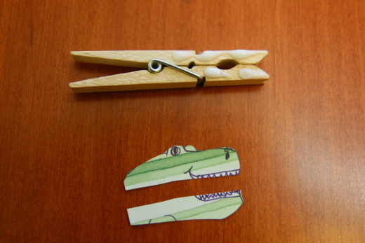 Cut out an animal shape, cut it in half, and glue it to a clothespin. Glue a letter to the back of the clothespin.