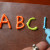 Use dimensional paint and pipe letters onto wax paper. Once dry, they will make window clings.