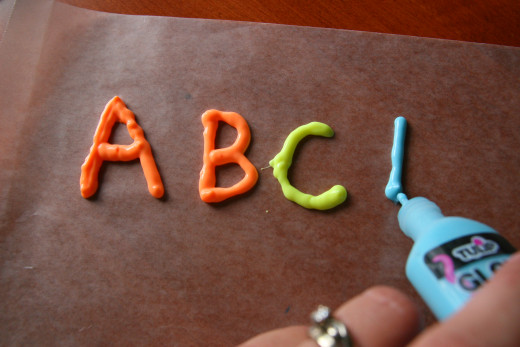 Use dimensional paint and pipe letters onto wax paper. Once dry, they will make window clings.
