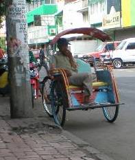 A three-wheeled pedicab or Becak.