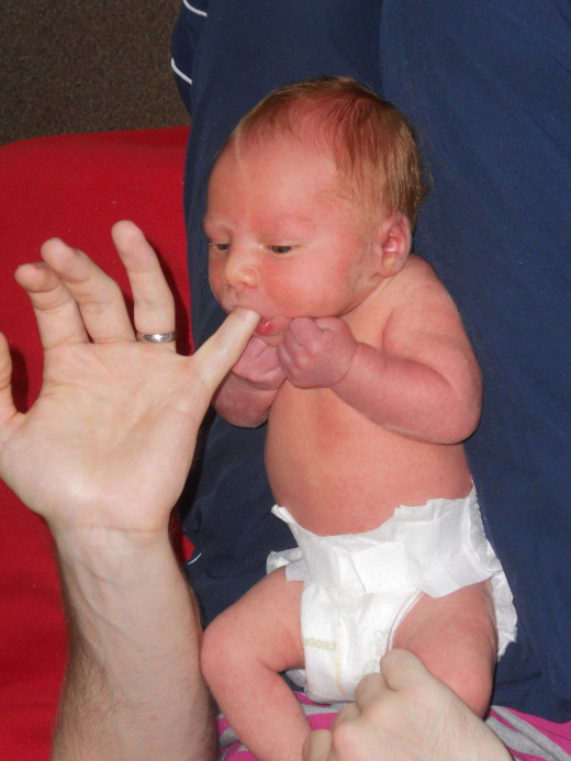 If your baby is too stressed to realise you are trying to feed them, place your *clean* finger in their mouth as shown. This will stimulate their suckling reflex and calm them almost instantly.