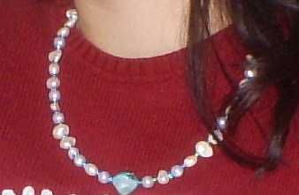 Create a simple and pretty necklace with blue and white beads.