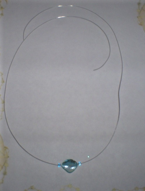Add a blue seed bead to each side of the necklace.