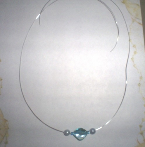 Add a fake light blue pearl bead to each side of the necklace.