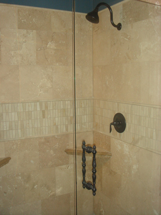 The floor tile was used for the shower walls and the tile in the stripe was used as the backsplash for the vanities.