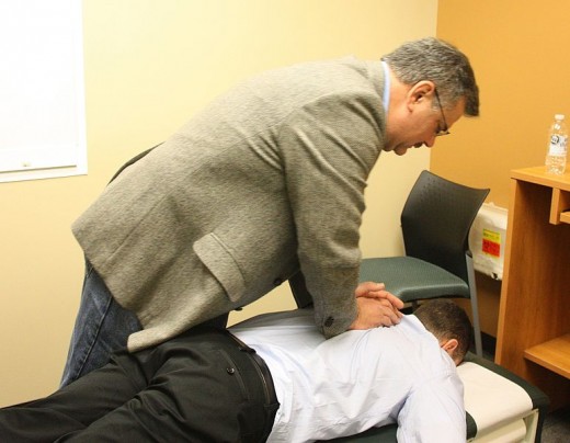 Chiropractor Jim Dubel demonstrating adjustment protocols.