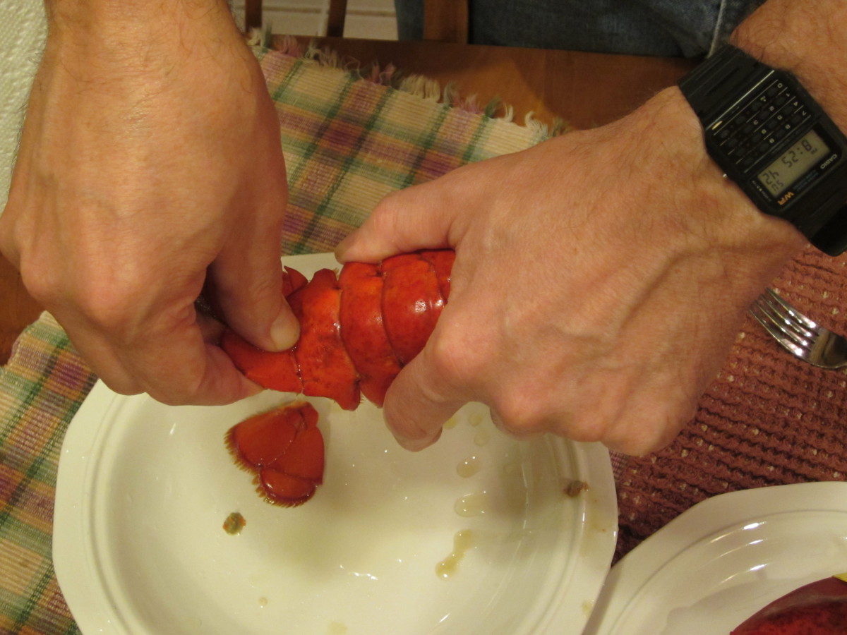 Removing the flippers from the tail of the lobster