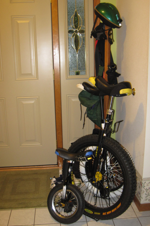 Unicycles and gear next to our front door.
