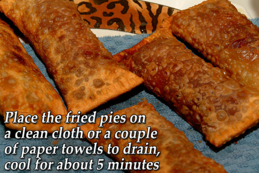 Remove  the golden brown pies from the hot oil and drain on a clean dry cloth. Cool for about five minutes before serving as the filling can be scalding hot.
