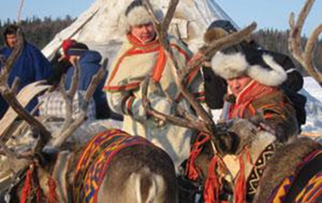 Saami people who have been deeply affected by climate change in traditional dress preparing for a cultural tradition.