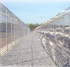 Concertina razor wire surrounds prison.