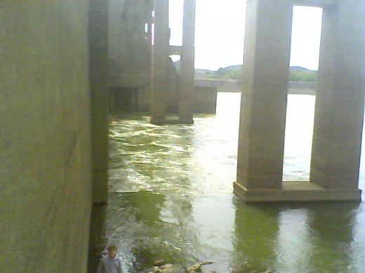 This wall view of the downriver side of Markland Dam shows the release of water churning the Ohio River close to shore. This wall view of the downriver side of Markland Dam shows the release of water churning the Ohio River close to shore.