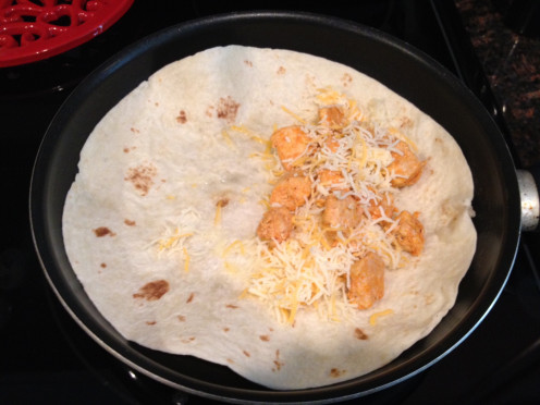 Chicken and cheese on one side of the tortilla