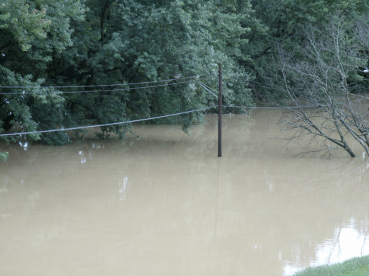 Telephone and electrical wires just a few feet from the rising waters.