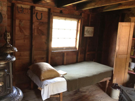 Although the stableman's room was petite, it was cozy. With a corner stove, he and any guests could keep warm during the chilly evenings.