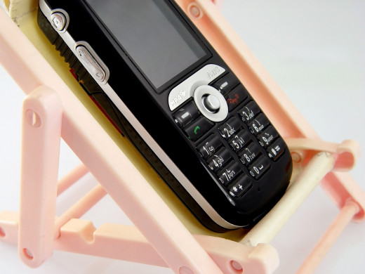 The mobile phones in rest by Yuyang DESCRIPTIONMobile phone resting on the deck chair