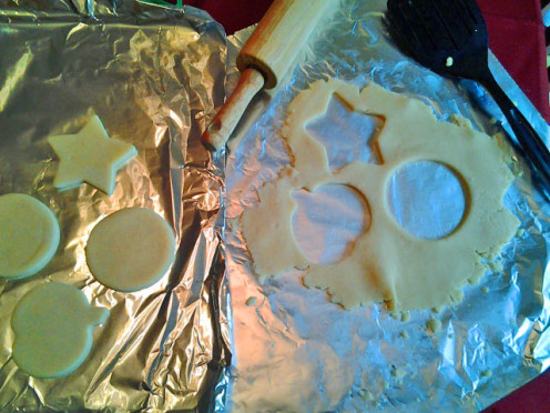 Cookie dough rolled out and shapes cut out