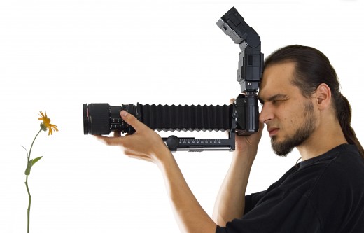 Young photographer with macro equipment.