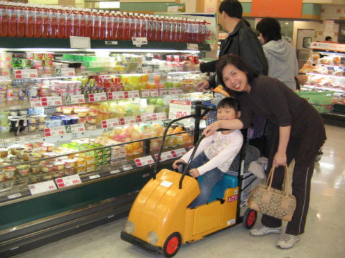Child driving shopping cart in Japan