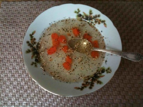 clear chicken bouillon with carrots and roasted sesame seeds