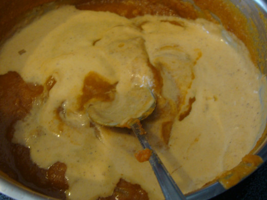 Add the cream to the pot of soup.