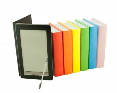 Row of colorful books and electronic book reader 
