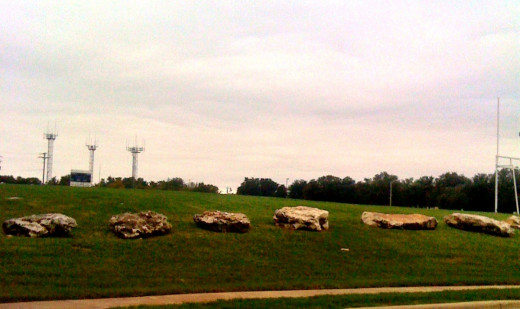 The football field bordered with rocks.