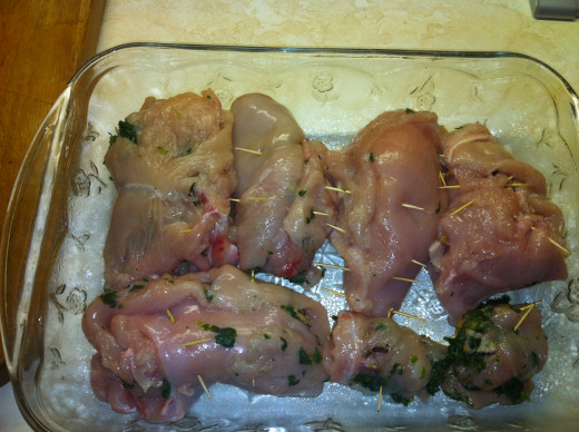 Once the chicken breasts are folded and toothpicks are in, place into the baking dish.