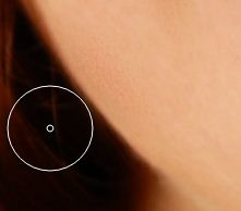 After using the touch up brush tool the blemish is gone.