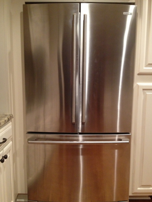 I use microfiber cloths with water to wipe my kids finger prints off the fridge.  It is cost easy and effective.