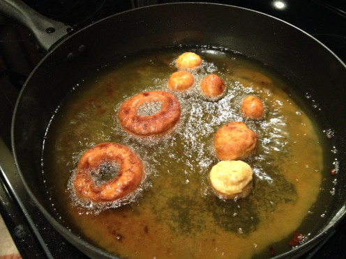Fry the doughnuts and holes in vegetable oil over medium-high heat.