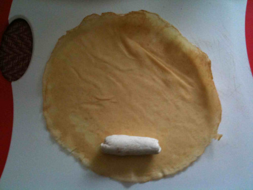 Rolling the blintzes with farmer cheese filling