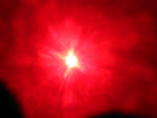Shown in the glare at the top of our sun is the outline of the planet Nibiru Planet X.