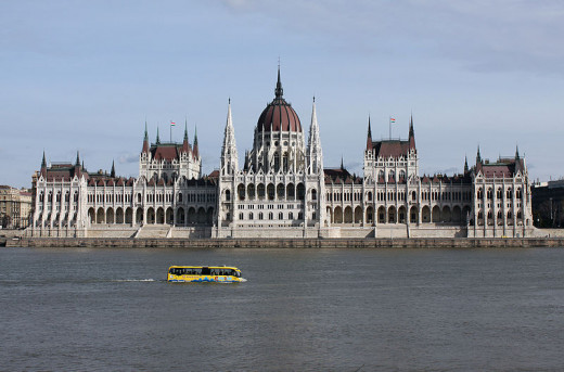 An amphibious sightseeing bus in front of the  House of Parliament in Budapest, Hungary was photographed by HoremWeb on February 27, 2010.