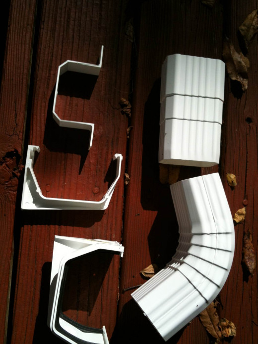 Upper Left: Downspout bracket, Middle Left: Support Bracket, Lower Left: Slip Joint Connector, Upper Right: Coupler, Lower Right: Elbow
