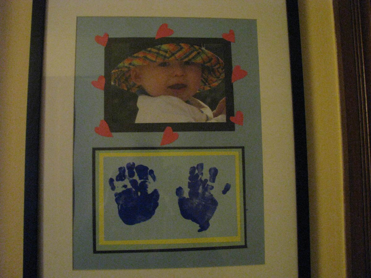 Take a photo of your child and make hand prints using finger paint for this homemade gift. 