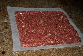 Roll out the meat in a baking pan or on wax paper.