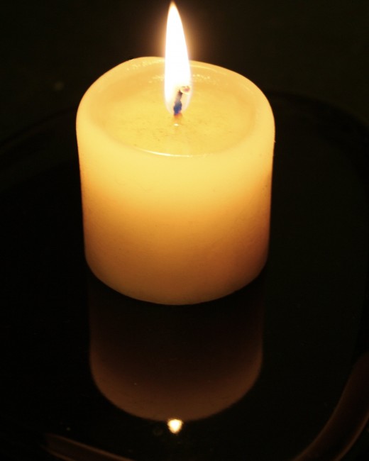 A single candle can help still the air and add a release of purity, burning off odors.  A scented candle adds a different dimension.