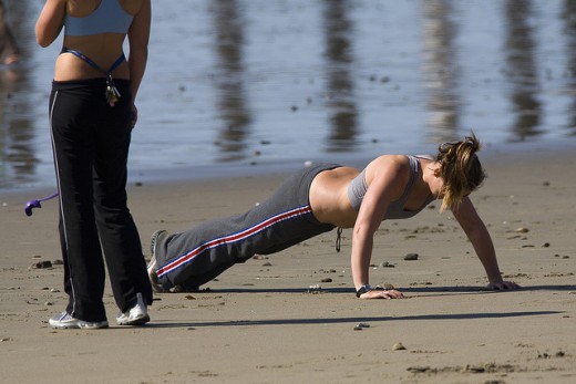 Two girls getting a workout in on the beach.
