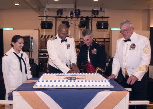 Okinawa, Japan (Oct. 9, 2004) - Commander Fleet Activities Okinawa, Capt. Robert D. Wilson, center left, and guest speaker, Commanding General, Marine Corps Bases, Japan, Lt. Gen. R. Blackman Jr., center right, cut the cake during the Navy 229th birt