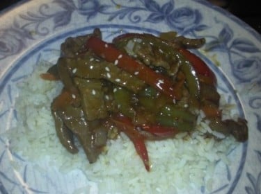Beef and veggie stir fry served over a bed of rice.