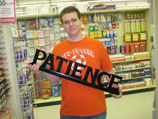 Man holding patience sign. 