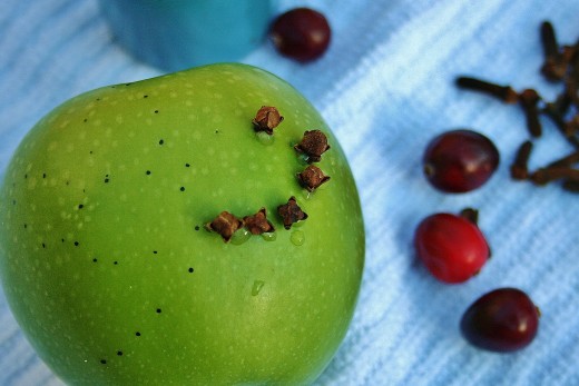 Piercing the fruit first makes inserting the cloves easier.
