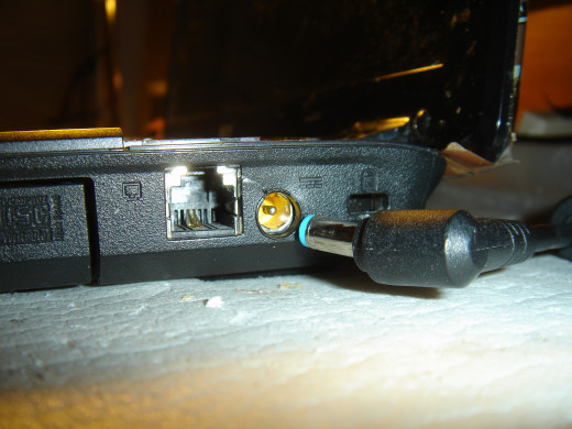 A crack near the power jack. The connector is tilted sideway. When it is turned with the wire to the rear, power is off.