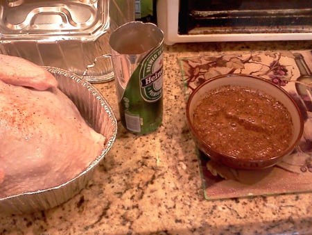 Beer Can Smoked Turkey preparation with beer and spices for basting.