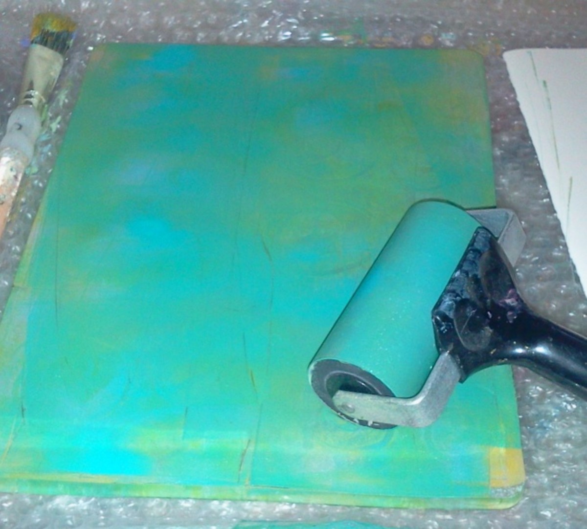 Spreading paint with a brayer.