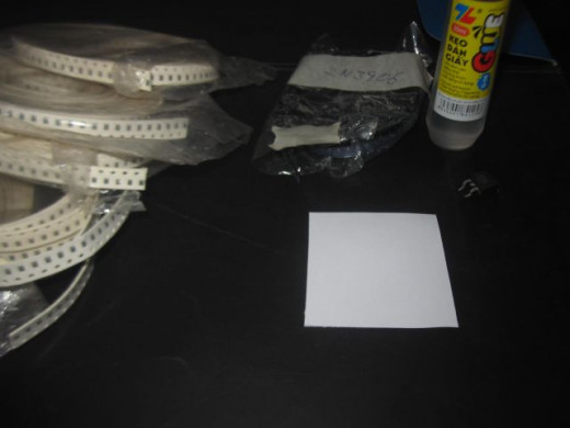 SMD components, a square of paper and water soluble paper glue.