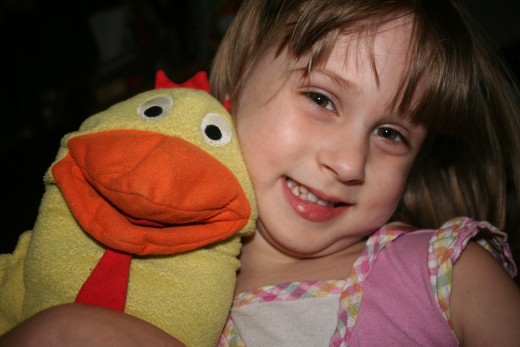 My daughter and the chicken puppet she received as a PST birthday party favor.